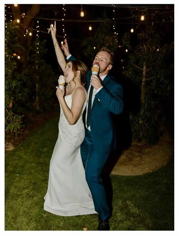 bride and groom eating ice cream and dancing