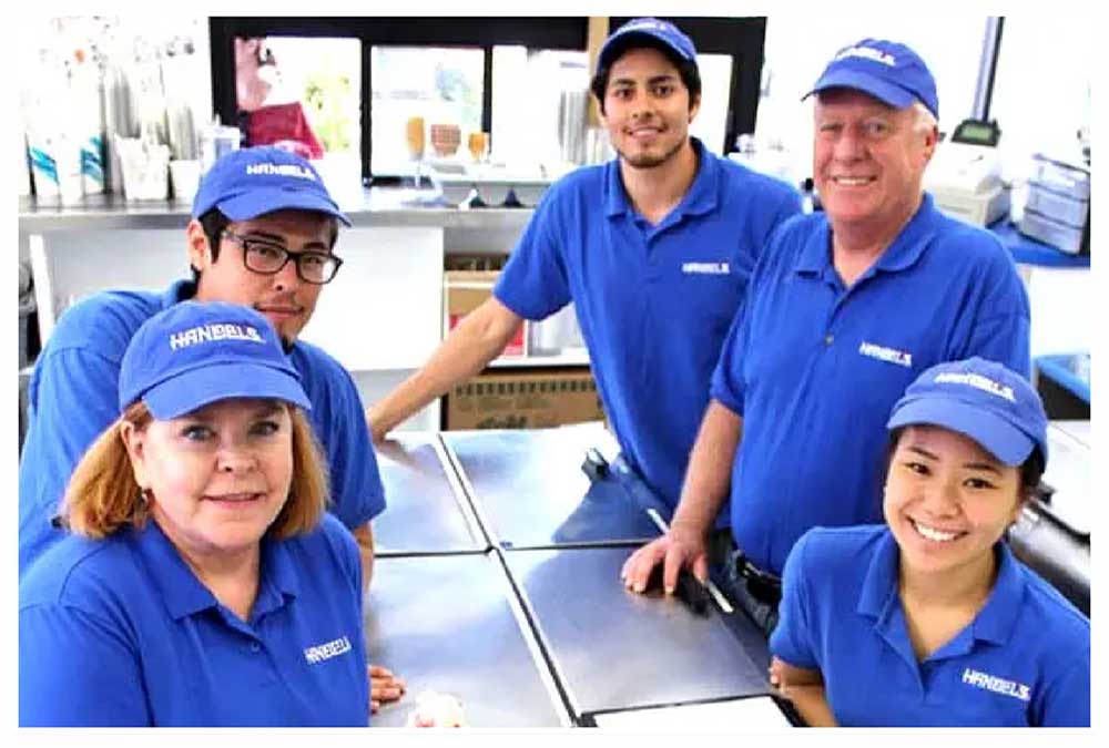 Handel's store team huddled around a table