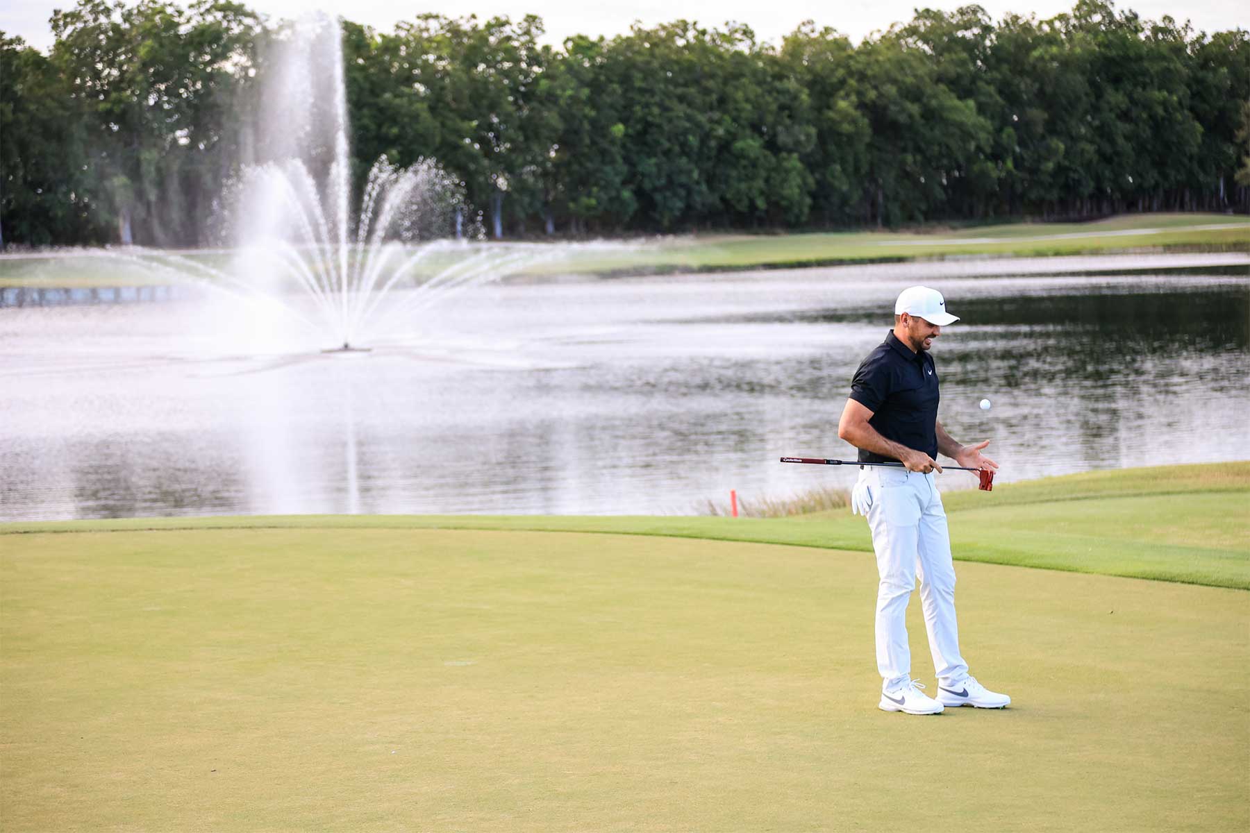 golfer standing on a putting green 