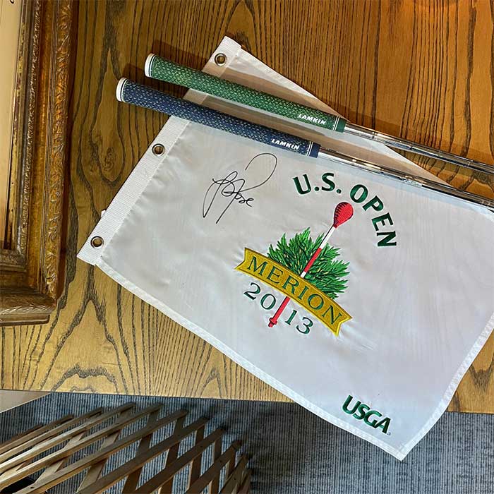 2013 U.S. Open flag autographed by Justin Rose with two Lamkin grips on top